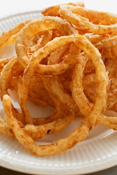 some onion rings are on a white plate