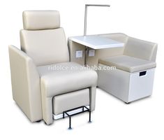 the chair and ottoman are all white with a small table on one end, and an arm rest