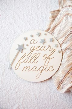 a wooden sign that says a year full of magic on it next to a tie