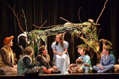 a group of people sitting on top of a stage