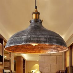 an industrial style light hanging over a kitchen island