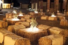 hay bales with flowers and candles on them