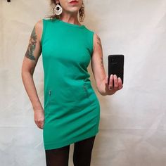 "Gap retro pinafore dress size uk6  Great on its own or with pretty blouse or roll neck under.  2 zipped front pockets and zip back Model size uk10 5ft 9\" tall  Measurements: 34\" bust (pit to pit) 33\" nape to hem 38\" hips Does have a little give/stretch to fabric. Nice quality material, medium weight fabric Good pre-loved condition  #gap #green #emerald #pinefore All orders are shipped using biodegradable and recycled packaging where possible" Retro Fitted Sleeveless Green Dress, Green V-neck Sleeveless Stretch Dress, Green Knee-length Mod Dress, Green Shift V-neck Mini Dress, Green Mod Cotton Dress, Vintage Green Dress, Retro Autumn, Autumn Dress, Pretty Blouses