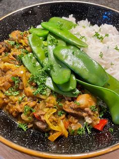 a plate filled with rice and green beans