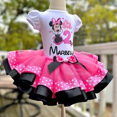 a pink and black dress with minnie mouse on it