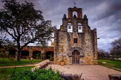 an old stone church with two bells on it