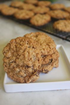 two oatmeal cookies sitting on top of a white plate