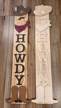 two wooden signs with cowboy hats and boots on them, one says hollywood the other says hollywood