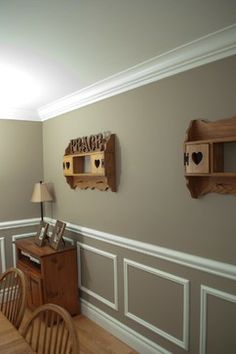 two wooden shelves on the wall in a dining room