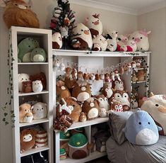 many stuffed animals on shelves in a room