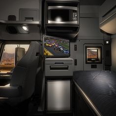 the interior of an airplane with two televisions on either side of the bed and one tv mounted to the wall