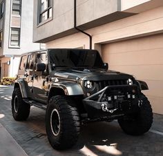 a black jeep parked in front of a building