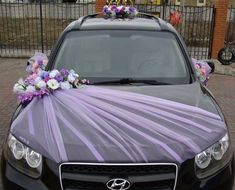 a car decorated with purple and white flowers