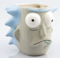 a ceramic mug with a face painted on it's side and eyes drawn to look like a monster