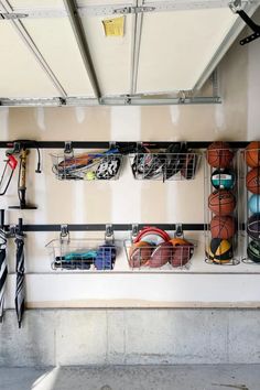 there are many sports equipment hanging on the wall