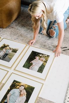 a woman is looking at photos on the floor