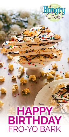 a happy birthday card with cake and sprinkles on the table next to it