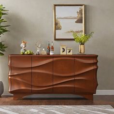 a living room with a large wooden dresser next to a potted plant