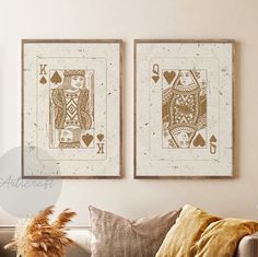 two framed playing cards sitting on top of a couch