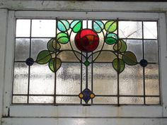 a close up of a stained glass window with flowers on the bottom and side panels