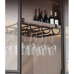 wine glasses and bottles are sitting on a shelf in front of a wall - mounted wine glass rack