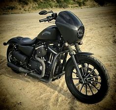 a black motorcycle is parked in the dirt