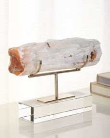 a large piece of wood sitting on top of a white table next to a book