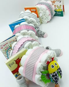 several diapers are lined up on a white surface, with books in the background