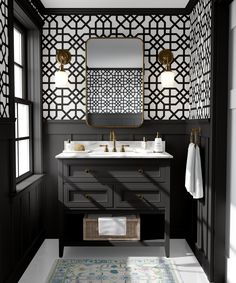 a black and white bathroom with gold accents