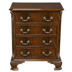 an ornate wooden chest of drawers with brass handles and knobs on each drawer,