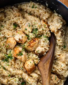 chicken and rice in a skillet with a wooden spoon on the side, ready to be eaten