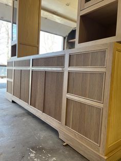 a large wooden cabinet sitting inside of a building