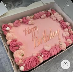 a pink birthday cake in a box with the words happy birthday written on it's side