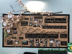 a bulletin board with pictures and rope on it in an office cubicle decorated with flowers