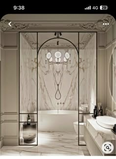 an elegant bathroom with marble walls and flooring, along with a white bathtub