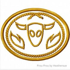 a gold emblem with an animal head in the center and two braids around it