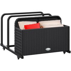 a black wicker storage unit with red and white pillows on it's sides