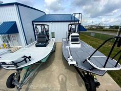 two boats parked next to each other in front of a building