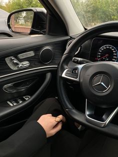 the driver's view of a mercedes c - class car with its steering wheel and dashboard