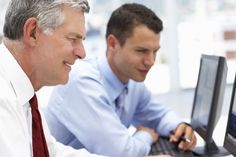 two men looking at a computer screen together