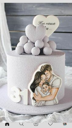 a cake decorated with an image of a man and woman holding a baby on top of it