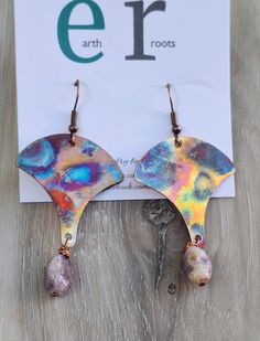 These boho shaped earrings feature fan shaped copper blanks that have been fire painted using a propane torch to bring out the different colors in the metal when heated.   NOTE:  Certain lighting will make the colors pop more than other types of lighting. They are finished with lepidolite gemstone bead dangles. These earrings will ship in a gift box via USPS with tracking info provided. Artsy Copper Drop Earrings, Unique Hand Painted Copper Jewelry, Unique Hand-painted Copper Jewelry, Artsy Copper Dangle Earrings, Nickel-free Copper Artsy Jewelry, Artsy Nickel-free Copper Jewelry, Bohemian Hand Painted Copper Jewelry, Bohemian Hand-painted Copper Jewelry, Teardrop Copper Jewelry For Festivals