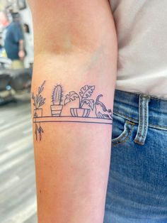 Thin Line Houseplant and Cat Tattoo on Bookshelf Cat On Shelf Tattoo, Above Back Of Elbow Tattoo, Shelf Tattoo Design, Cat Arm Band Tattoo, Plant Lady Tattoo Ideas, Plant Tattoo Ideas Female, Cat Arm Tattoos For Women, Plant And Cat Tattoo, Plant Book Tattoo