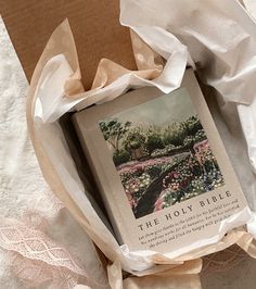 an open book on top of a bed covered in white sheets