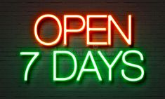 an open 7 days neon sign with the words'open 7 days'in green and red