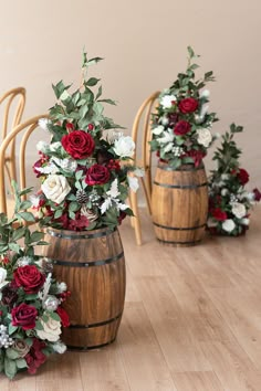 three wine barrels with flowers and greenery in them sitting on the floor next to each other