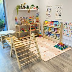 a child's playroom with toys and bookshelves on the floor in front of a window