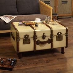 two suitcases sitting on top of a wooden floor next to a couch and lamp