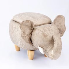 an elephant shaped ottoman with wooden legs on a white background in the shape of a footstool