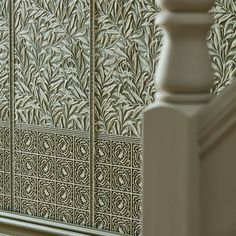 a close up view of a wall with decorative tiles